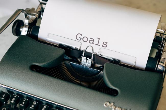 typewriter with a page that says goals