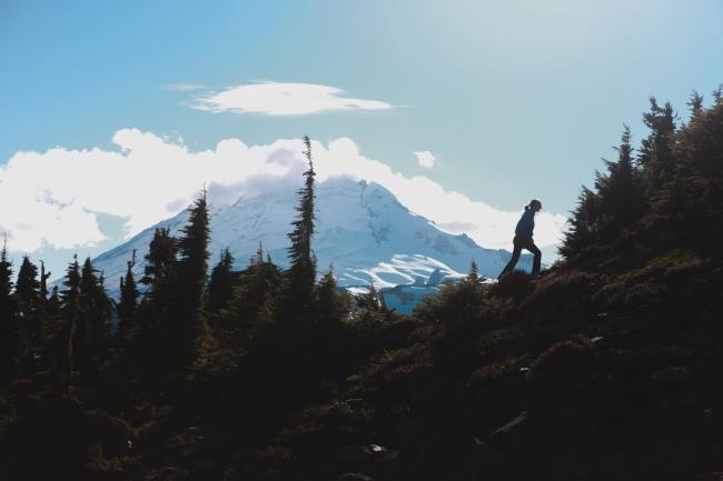 person hiking with Mt. Baker in the distance